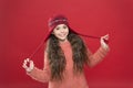 Just want to have fun. Winter outfit. Cute model enjoy winter style. Small child long hair wear hat. Wintertime concept