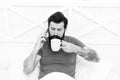 Just want to sip coffee. Bearded man talk on phone drinking coffee in bed. Drinking tea habit. Drinking cocoa. Enjoy Royalty Free Stock Photo