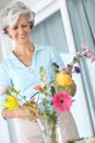 Just the way she likes it. a senior woman enjoying some flower arranging at home. Royalty Free Stock Photo