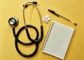 Just what the doctor prescribed. Studio shot of a stethoscope, notepad, pen and pills against a yellow background.