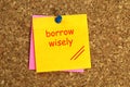 Borrow wisely postit on cork