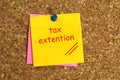 Tax extention postit on cork Royalty Free Stock Photo