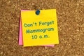 don\'t forget mammogram 10 a.m. postit on corkboard Royalty Free Stock Photo