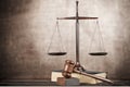 Justice Scales and books and wooden gavel on table Royalty Free Stock Photo