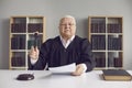 Senior judge pronounces sentence, rules case closed and hits sound block with gavel Royalty Free Stock Photo