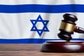 Justice and court concept in State of Israel. Judge hammer on a flag background