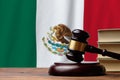 Justice and court concept in United Mexican States. Judge hammer on a Mexico flag background