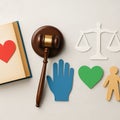 Judge gavel with balance and heart symbol, representing justice with empathy, human rights, fairness, compassion, and equality. Royalty Free Stock Photo