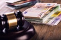 Justice and euro money. Euro currency. Court gavel and rolled Euro banknotes. Representation of corruption and bribery in the judi Royalty Free Stock Photo