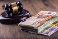 Justice and euro money. Euro currency. Court gavel and rolled Euro banknotes. Representation of corruption and bribery in the judi Royalty Free Stock Photo