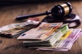 Justice and euro money. Euro currency. Court gavel and rolled Euro banknotes. Representation of corruption and bribery in the judi Royalty Free Stock Photo