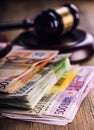 Justice and euro money. Euro currency. Court gavel and rolled Euro banknotes. Representation of corruption and bribery in the judi Royalty Free Stock Photo