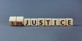 Justice instead of injustice. Turned cubes and changed the word `injustice` to `justice` on wooden cubes. Beautiful grey