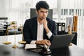 Justice and law concept. Asian Male judge in a courtroom  the gavel, working with smart phone and laptop and digital tablet Royalty Free Stock Photo