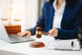 justice and law concept.law theme wooden desk, books, balance. Male judge in a courtroom the gavel,working with digital tablet Royalty Free Stock Photo