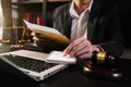 Justice and law concept.Male judge in a courtroom with the gavel, working with, computer and  docking keyboard, eyeglasses, on Royalty Free Stock Photo