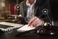 Justice and law concept.Male judge in a courtroom with the gavel, working with, computer and  docking keyboard, eyeglasses, with Royalty Free Stock Photo