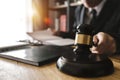 Justice and law concept.Male judge in a courtroom with the gavel,working with,digital tablet Royalty Free Stock Photo