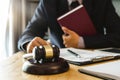 Justice and law concept.Male judge in a courtroom with the gavel,working with,digital tablet Royalty Free Stock Photo