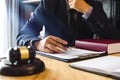 Justice and law concept.Male judge in a courtroom with the gavel,working with,digital tablet Royalty Free Stock Photo