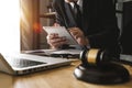 Male lawyer in the office with brass scale on wooden table. justice and law concept in morning light