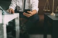 Justice and Law context.Male lawyer hand sitting on sofa and wor