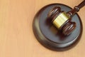 Justice mallet on wooden desk in a courtroom during a judicial trial. Law concept and empty space for text. Judge hammer