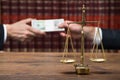Justice Scale On Table With Judge Taking Bribe From Client Royalty Free Stock Photo