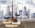 Justice Scales and books and gavel on cityscape Royalty Free Stock Photo