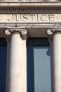 Justice sign on a law courts courthouse building, vertical Royalty Free Stock Photo