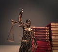 Justice statue in front of a pile of law books Royalty Free Stock Photo