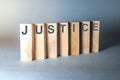 Justice word on wooden blocks on blue background, law concept Royalty Free Stock Photo