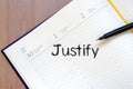 Justify write on notebook Royalty Free Stock Photo
