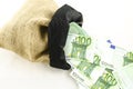 Jute bag full of money Royalty Free Stock Photo