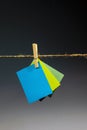 Multicolor cards Hanging from a clothes peg on a jute clothesline on a black background Royalty Free Stock Photo