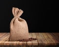 Jute coffee bag and beans isolated on the wood background Royalty Free Stock Photo