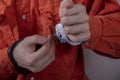 A juvenile delinquent tries to open the handcuffs with a paper clip.concept: attempt to escape from custody, opening locks, violat