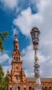 Juxtaposition of blue and white ceramic azulejo tiles against one of the baroque sandstone tower at Plaza de Espana in Seville, Sp Royalty Free Stock Photo