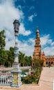 Juxtaposition of blue and white ceramic azulejo tiles against one of the baroque sandstone tower at Plaza de Espana in Seville, Sp Royalty Free Stock Photo