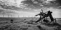 Old and new technology - wind turbines and abandoned plough - black and white Royalty Free Stock Photo