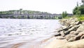 Jyvaskyla, Finland. Lake and the bridge of Kuokkala. Waves hitting rocks. Beautiful Finnish nature. Sunny summer landscape.