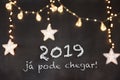 `2019 jÃÂ¡ pode chegar` in portuguese means `2019 can already arrive` in black background with blurred stars and light