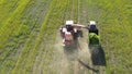 4K Aerial Elevated View Of Combine Harvester And Tractor Working Together In Field. Harvesting Of Oilseed In Spring Royalty Free Stock Photo