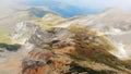 4K. Aerial. Flight in mountains like bird through clouds over rocks Royalty Free Stock Photo