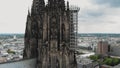 4k Aerial footage circling the historical Cologne Cathedral during it\'s renovation construction in Cologne, Germany.