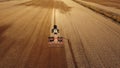 4K. Aerial view of agriculture process: tractor plows and makes seeding, sowing agricultural crops at field