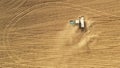 4K Aerial View Tractor With Seed Drill Machine Sowing Seeds For Crops In Spring Season. Beginning Of Agricultural Spring