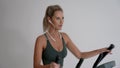 4K Beautiful woman working out on crosstrainer at home