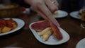 4K, Close up of woman hands holding a Iberico lomo in spanish bar. Tapas