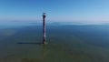 4K. Flight over old lighthouse standing in the sea, aerial view. Estonia, Saaremaa island - Kiipsaare tuletorn